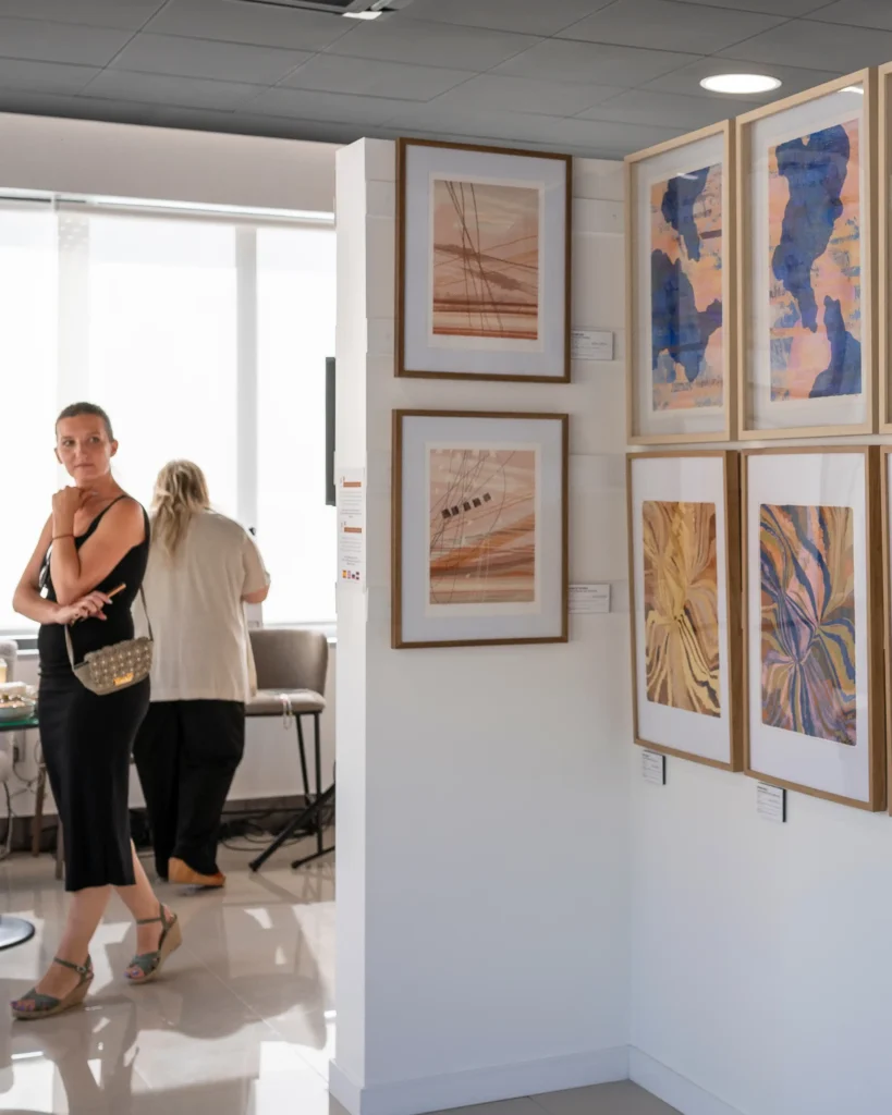 A viewer engaging with contemporary art in a gallery setting, using visual perception as a tool for strategic thinking and creative problem-solving.